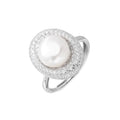 Silver ring with lustrous white pearl center surrounded by sparkling crystal halo on light background.