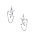 Silver star studs with crescent moon cutouts and zirconia stones connected by delicate chains on white background