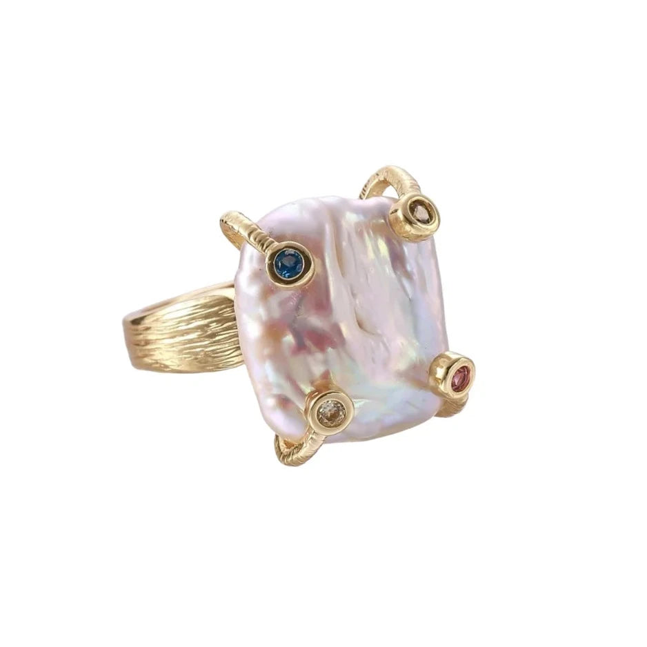 Gold ring with large iridescent baroque pearl and four colored gemstones on textured band