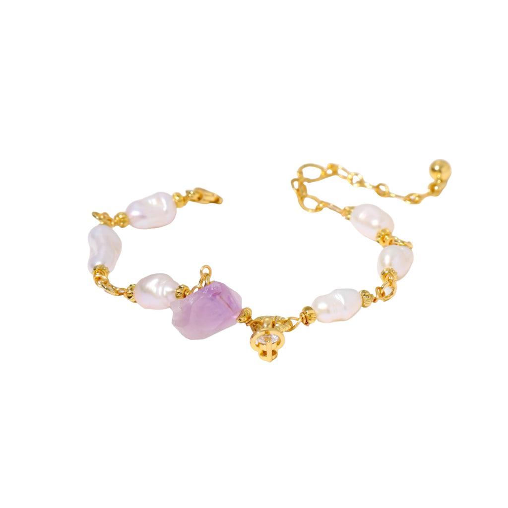 Gold-plated bracelet with lustrous baroque pearls and raw lavender amethyst centerpiece on white background.