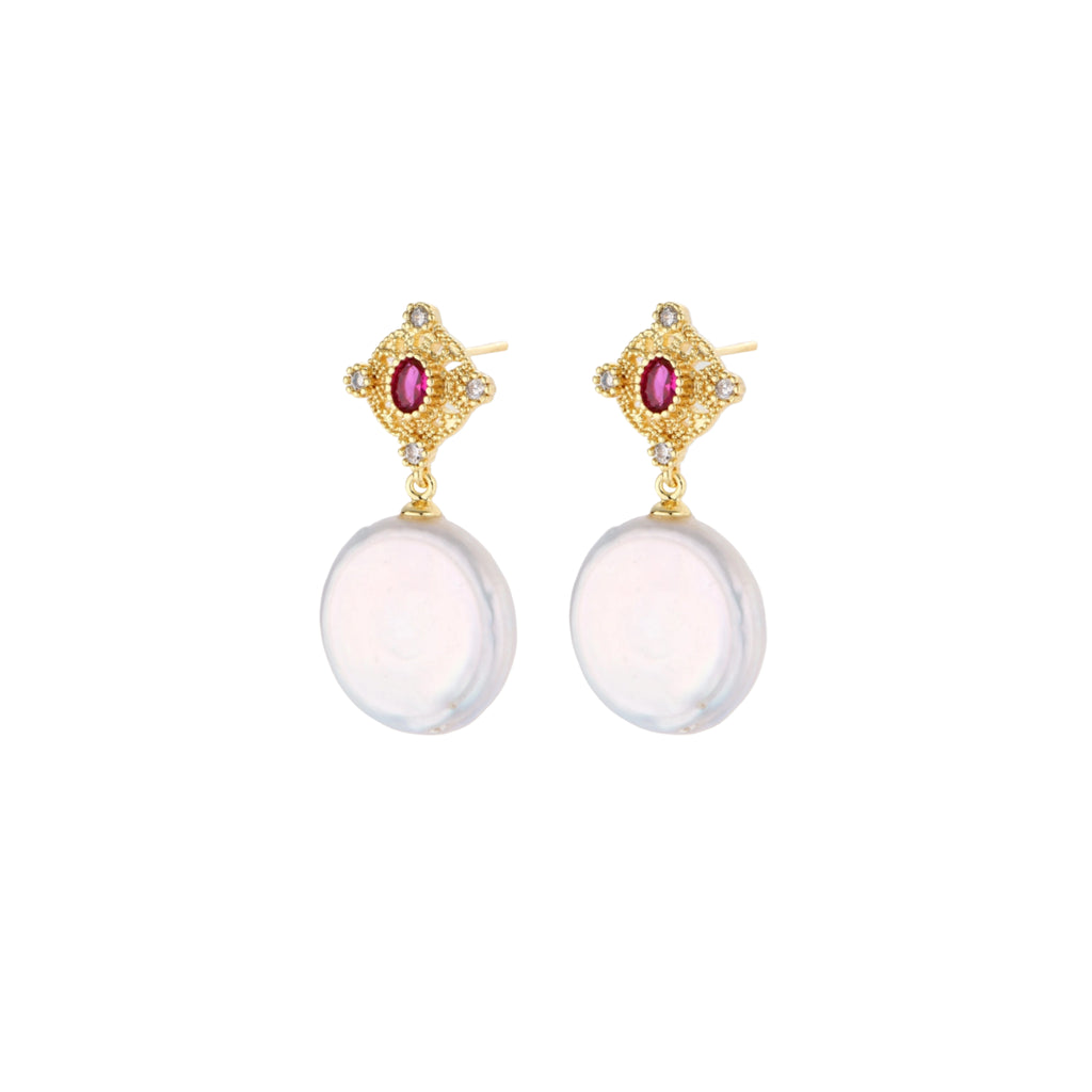 Gold baroque pearl earrings with pink gemstone studs and ornate detailing on cream background.