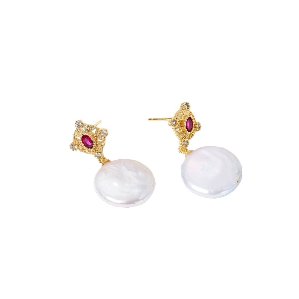 Gold baroque pearl earrings with pink gemstone studs and ornate detailing on cream background.