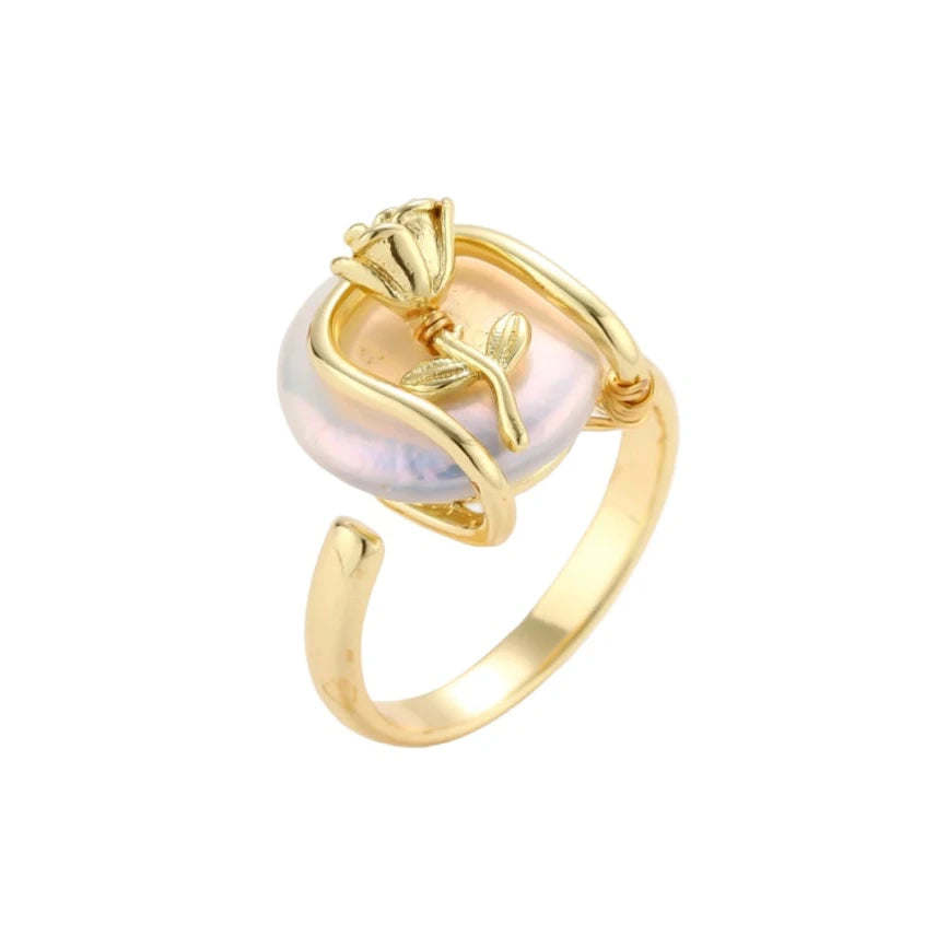 Gold-plated sculptural ring featuring a baroque pearl wrapped in a delicate rose and vine cage design