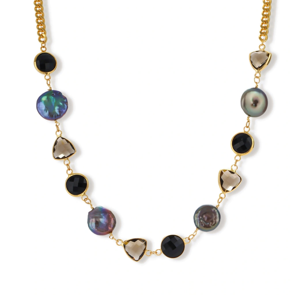 18k gold-plated chain necklace featuring lustrous baroque pearls, black onyx rounds, and smoky quartz triangular stones on white background.