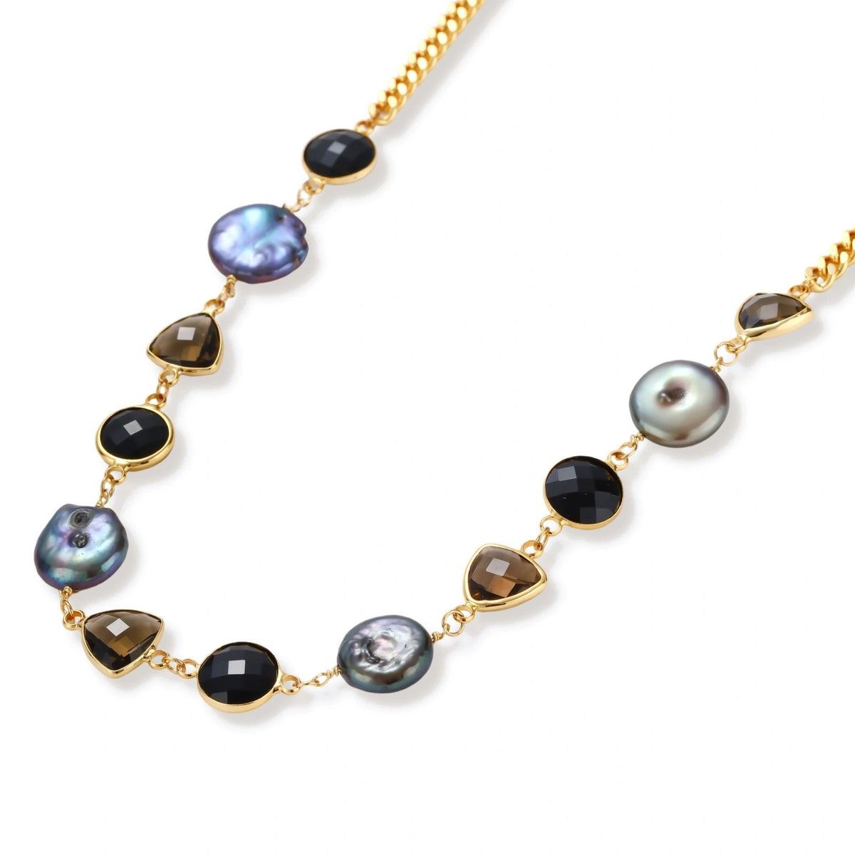 18k gold-plated chain necklace featuring lustrous baroque pearls, black onyx rounds, and smoky quartz triangular stones on white background.